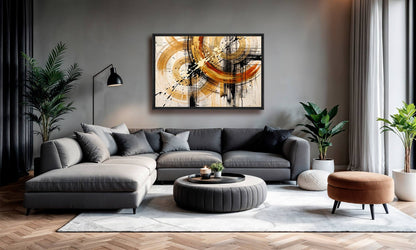 A modern living room featuring a large framed abstract canvas print with gold, black, and white brushstrokes on a gray wall above a gray sectional sofa.