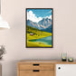 Framed artwork of a mountain landscape hanging on a wall above a wooden cabinet.