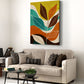 Colorful leaf painting above a beige sofa in a living room.