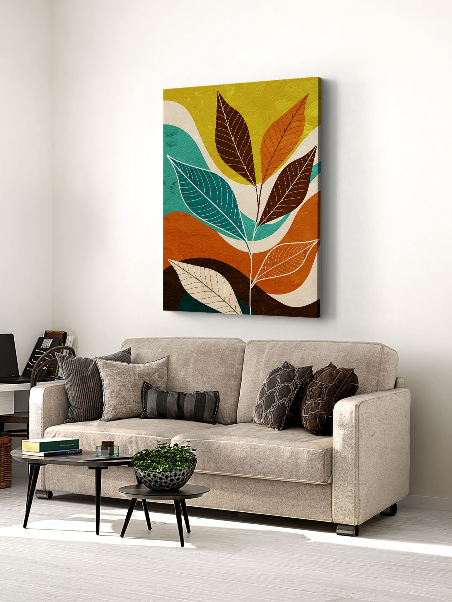 Colorful leaf painting above a beige sofa in a living room.