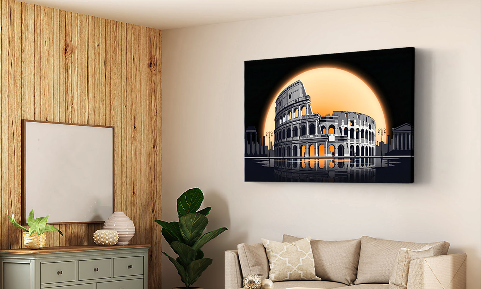 A rectangular wall art print showing the Colosseum under a large glowing orange sun, displayed on a beige wall in a modern living room with a sofa, wood-paneled wall, and plants.