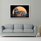 A framed wall art print depicting the Colosseum in Rome under a large orange moon, displayed on a light gray wall above a modern gray sofa in a styled living room.