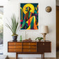 A framed colorful art print featuring an abstract figure with a yellow halo, displayed on a white wall above a mid-century modern wooden sideboard with a lamp and potted plant.
