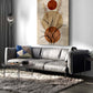Modern living room with a gray sofa, abstract wall art, and a rug.
