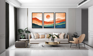 Modern living room with a gray sofa, coffee table, and wall art depicting a sunset.