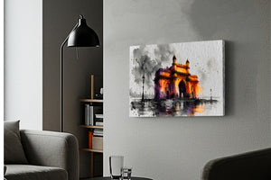 A rectangular canvas wall art print depicting a stylized illuminated monument in orange, yellow, purple, and black tones, mounted on a light gray wall in a modern living room setting with a black floor lamp, gray sofa, and shelving visible.