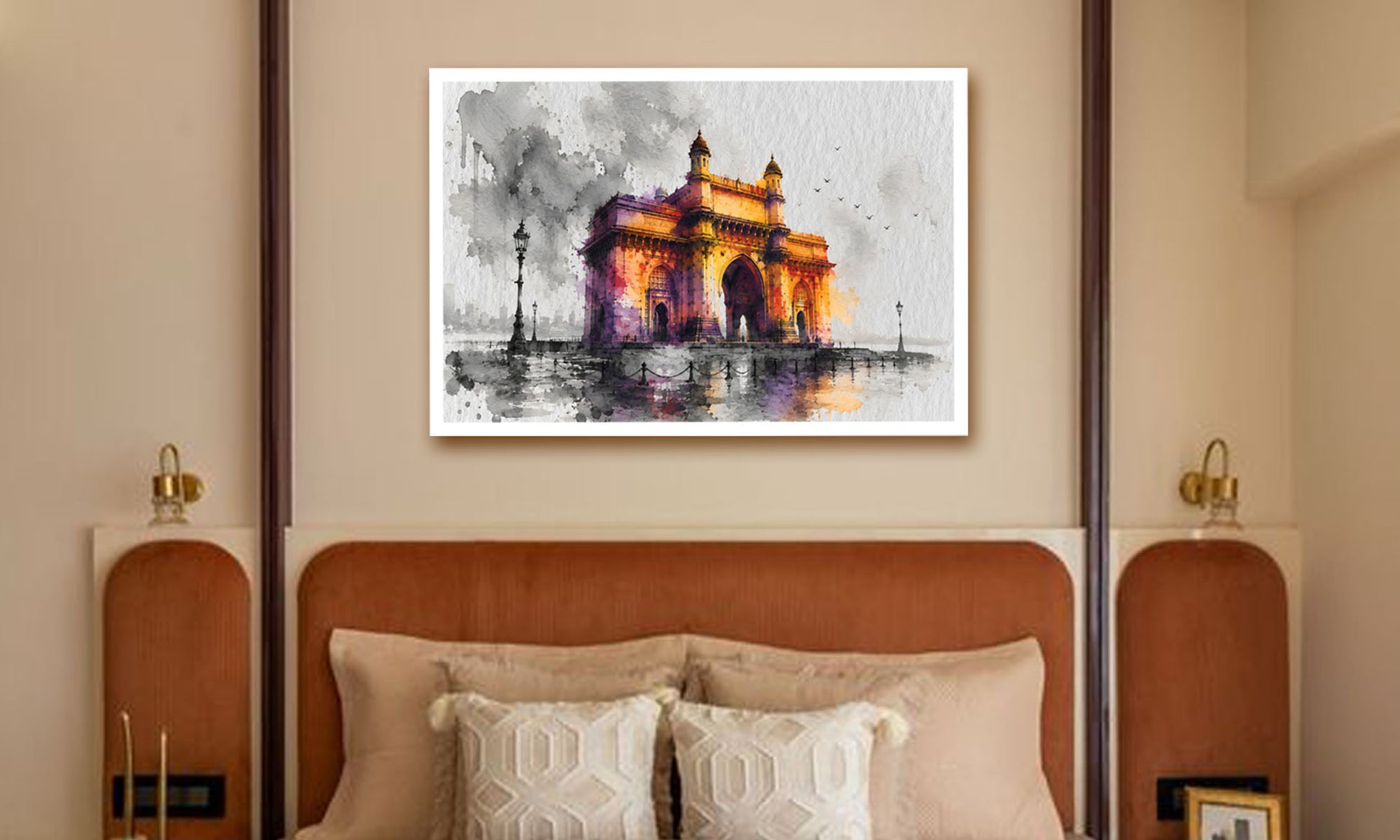 A framed watercolor painting of the India Gate monument in Kolkata, displayed on a beige wall above a bed with a brown headboard and neutral pillows.