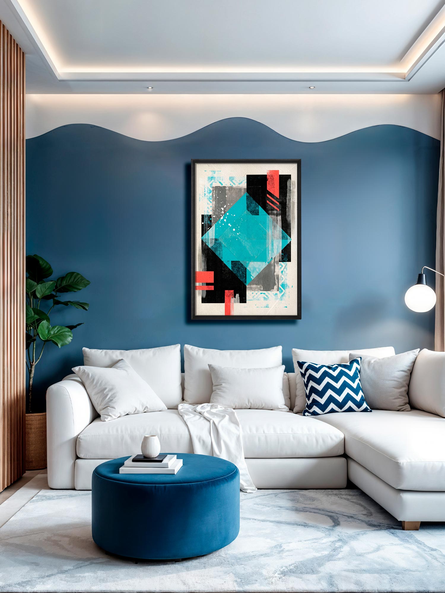 A modern living room featuring a white sectional sofa with decorative pillows, a round blue velvet ottoman, and a blue accent wall with a wavy pattern. A framed abstract geometric art print hangs on the wall above the sofa.
