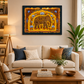 A framed golden wall art print featuring a golden elephant illustration hangs on a beige wall above a cream-coloured sofa in a styled living room setting.