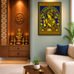 A framed gold and blue wall art print depicting a Krishna deity, styled in a modern living room setting next to a beige sofa and a wooden altar.