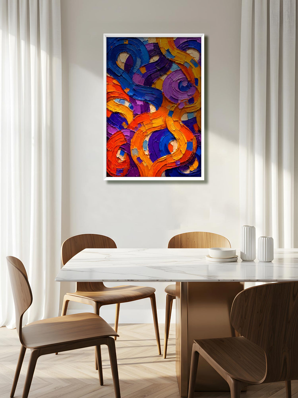 An abstract canvas painting with swirling brushstrokes of orange, purple, blue, and yellow, displayed on a light gray wall above a dining table with wooden chairs in a bright, modern room.