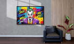 Colorful framed artwork of the Joker character on a wall in a living room.