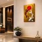 A vertical golden canvas wall art depicting two koi fish (one red, one white) swimming around a red sun on a textured gold background, displayed on a beige wall in a modern, well-lit lobby with a wooden console table and a light beige armchair.
