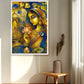 A framed vertical art print featuring a stylized golden woman with a peacock and lotus motifs, displayed on a beige wall in a sunlit room above a small wooden stool with a vase.