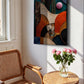 Abstract wall art canvas print hanging on a white wall in a sunlit room, styled with a wooden chair, small round table, and pink roses in a glass vase.