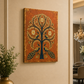 A vertical canvas wall art print featuring a stylised tree of life with peacocks, displayed on a beige wall in a modern interior setting.