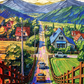 Countryside mountain canvas wall art featuring a colorful village road, charming homes, green fields, and majestic mountain scenery.