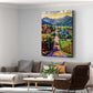 Countryside mountain canvas wall art featuring a colorful village road, charming homes, green fields, and majestic mountain scenery.