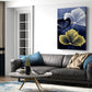 Living room with a gray sofa, coffee table, and floral artwork on the wall.
