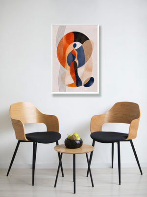 A framed abstract art print featuring orange, navy, beige, and black organic shapes, displayed on a white wall above a small wooden table with two modern wooden chairs.