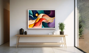A colorful abstract wall art print with flowing curved shapes in blue, purple, orange, yellow, and red, displayed in a white frame on a light gray wall above a wooden console table in a modern interior setting.