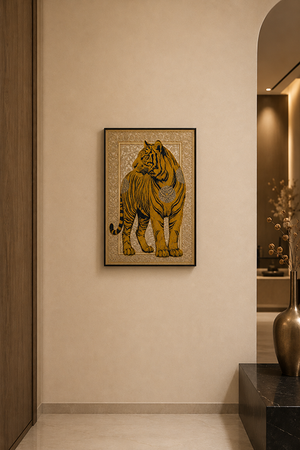 A framed wall art print featuring a golden tiger on a beige background, displayed in a modern interior hallway with warm lighting and a dark console table.