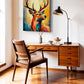 A colorful canvas wall art print of a deer with large antlers, displayed in a modern home office setting above a mid-century wooden desk and chair.