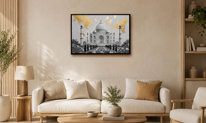 A framed art print of the Taj Mahal with gold leaf accents, displayed on a beige wall above a modern white sofa in a styled living room.