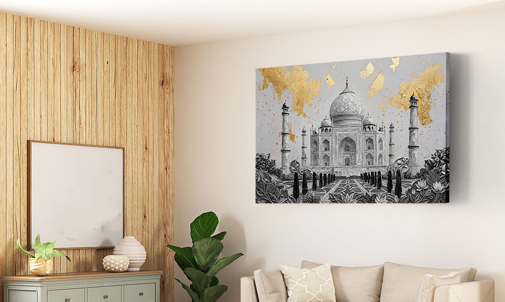 A square wall art print depicting the Taj Mahal with gold leaf accents, shown hanging on a beige wall in a modern living room setting with a sofa, wood-paneled wall, and plant.