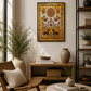 A framed colourful golden canvas wall art print featuring a sun motif and stylised figures, displayed in a warm, modern living room setting with a wooden chair, coffee table, and shelving.