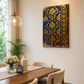 A vertical rectangular wall art piece featuring an ornate navy blue and gold damask pattern, displayed in a modern dining room setting above a wooden table with cream chairs.