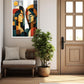 A framed abstract art print featuring two stylized faces in geometric shapes, displayed on a beige wall in a modern living room setting next to a wooden door and a potted plant.