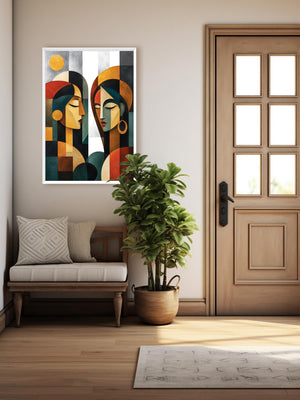 A framed abstract art print featuring two stylized faces in geometric shapes, displayed on a beige wall in a modern living room setting next to a wooden door and a potted plant.