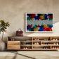 A colorful abstract canvas print with a white frame hangs on a beige wall above a wooden shoe cabinet in a modern, sunlit entryway.
